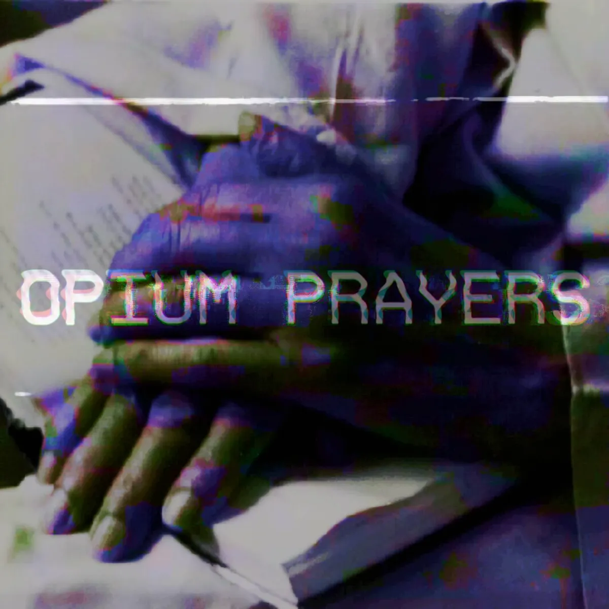 Hands folded over a Bible.