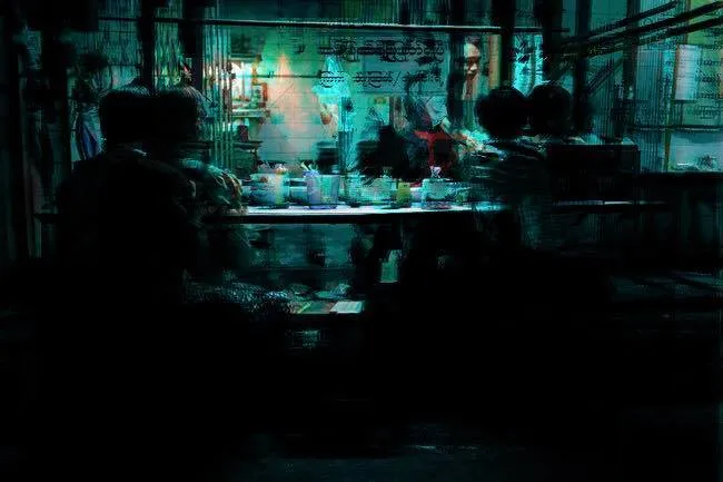 Distorted scene of people sitting at a street noodle bar