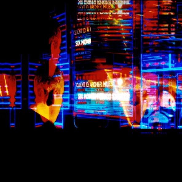 A man looking at many screens